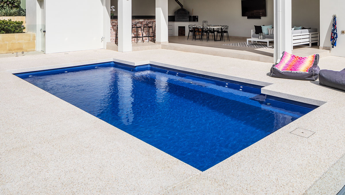 A contemporary pool with considered paving and landscaping
